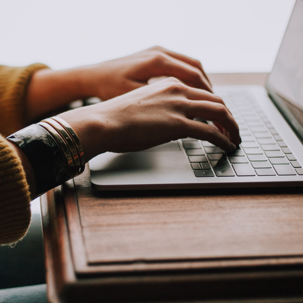 Hands typing on a keyboard